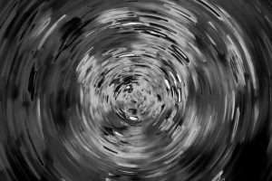 Abstract black-and-white vortex representing the emotional pull and confusion of sexual grooming